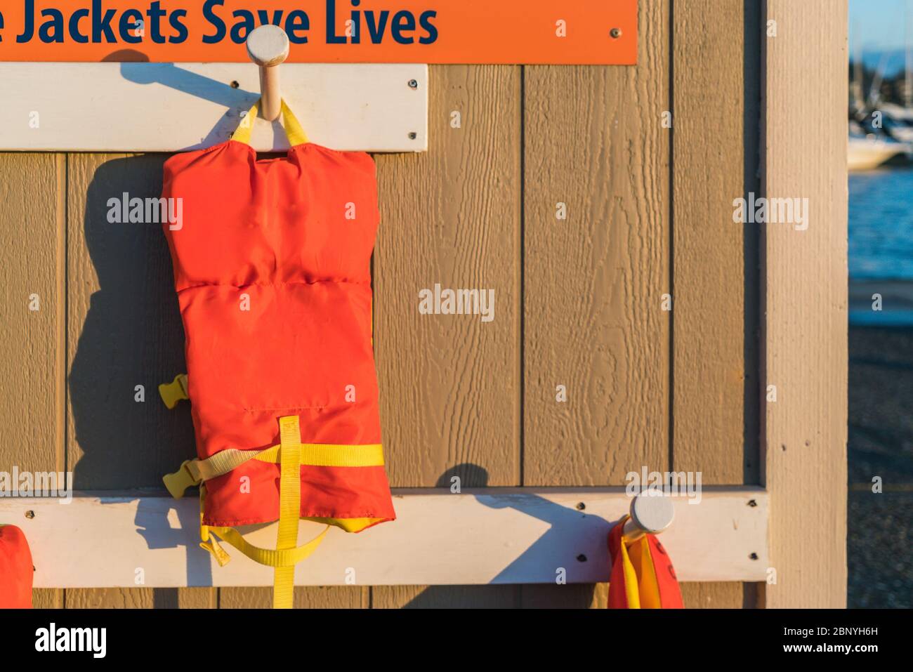 life jacket hang on the wall with sunset and copy space Stock Photo - Alamy