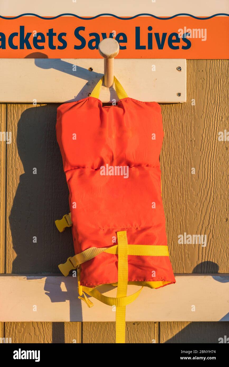 life jacket hang on the wall with sunset and copy space Stock Photo - Alamy