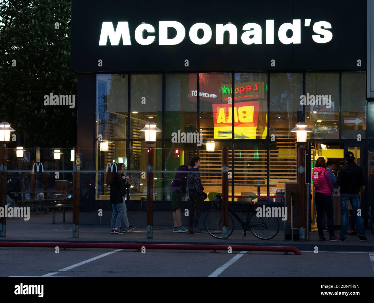 Visitors stand in line at McDonald's in the evening Stock Photo - Alamy