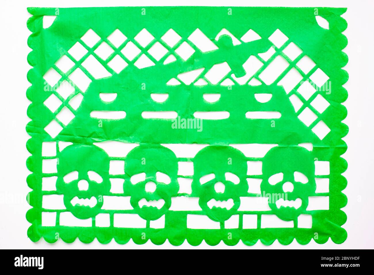 Day of the Dead, Papel Picado. Green Real traditional Mexican paper cutting flag. Isolated on white background. Stock Photo