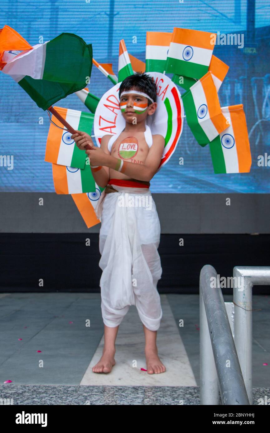 Indian kid waving the national flag at the stage. Stock Photo