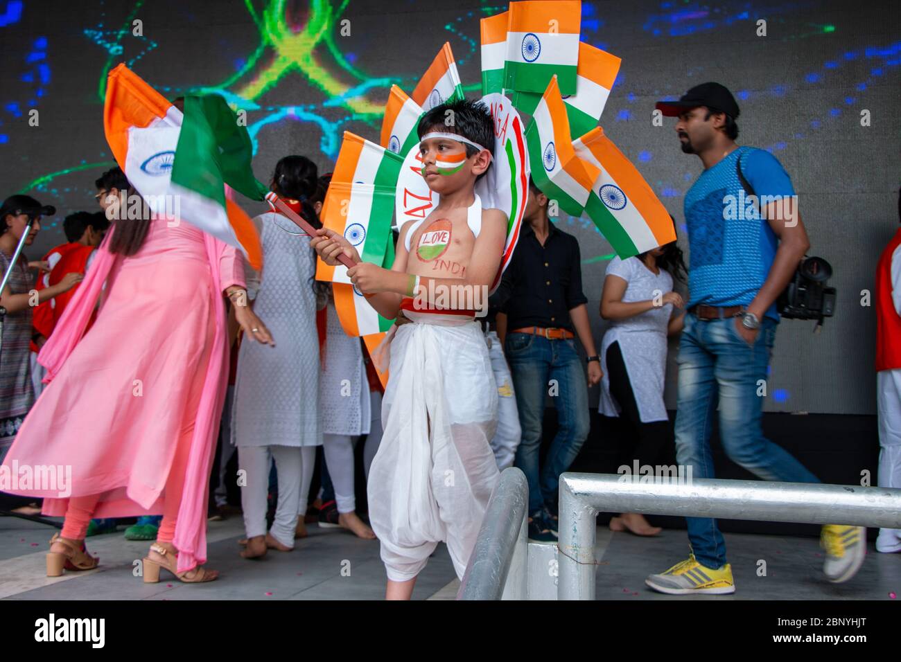 Indian kid waving the national flag at the stage. Stock Photo