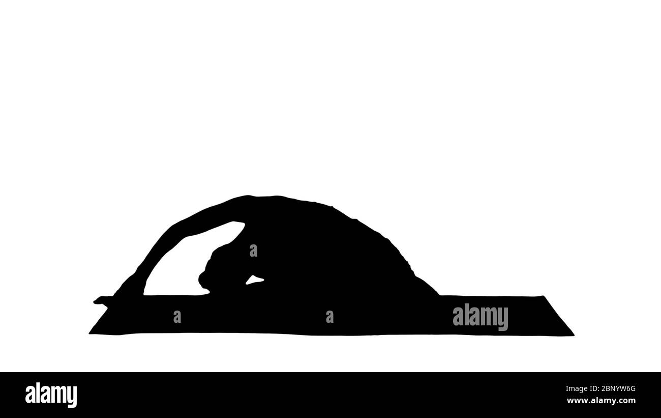 Silhouette Beautiful young woman wearing white clothing doing yoga exercise. Sitting in One-Legged King Pigeon (Single Pigeon) Pose. Stock Photo