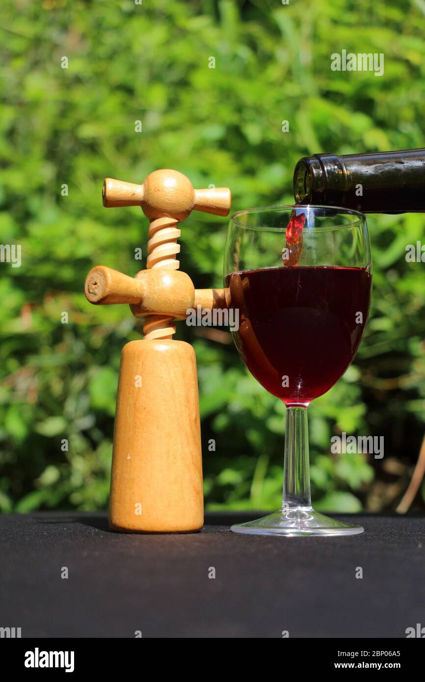 A glass of wine and a corkscrew Stock Photo