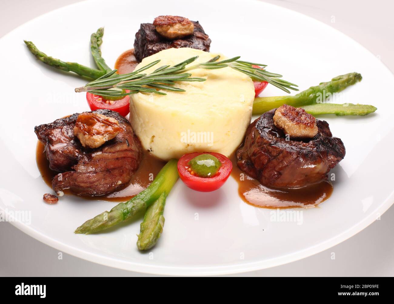 Filet mignon with asparagus and mashed potatoes on a white plate Stock  Photo - Alamy