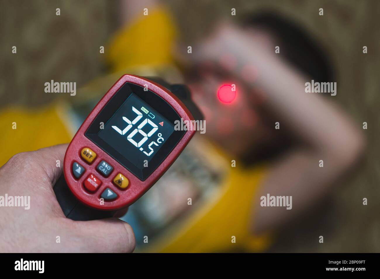 Measuring temperature of child with contactless thermometer. infrared