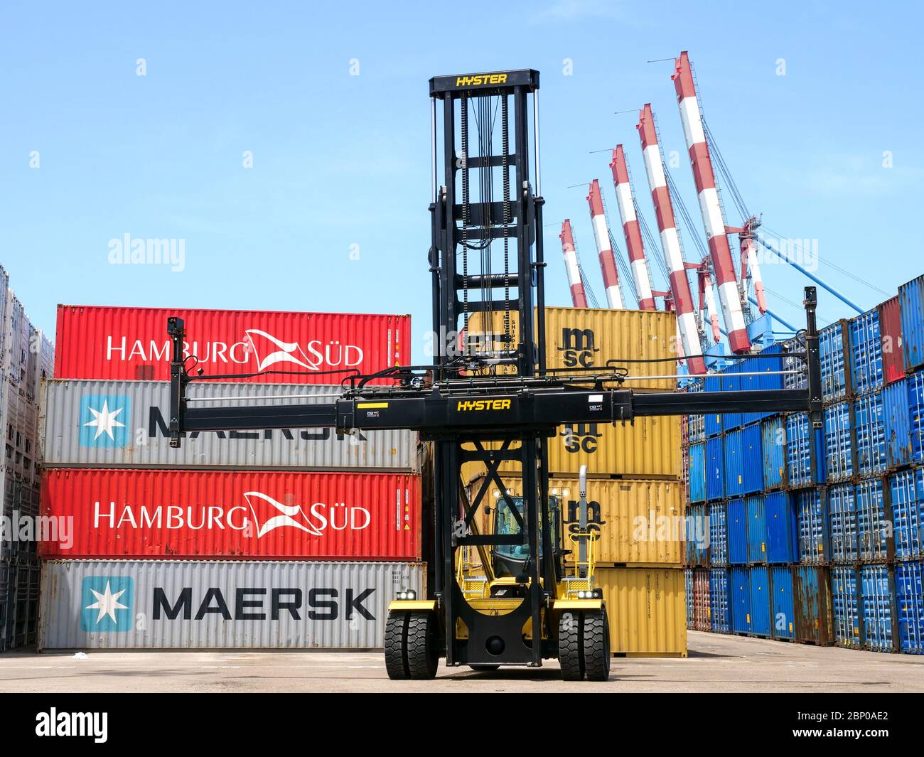 Hyster Container handler lifting a Shipping container in a local port. Stock Photo