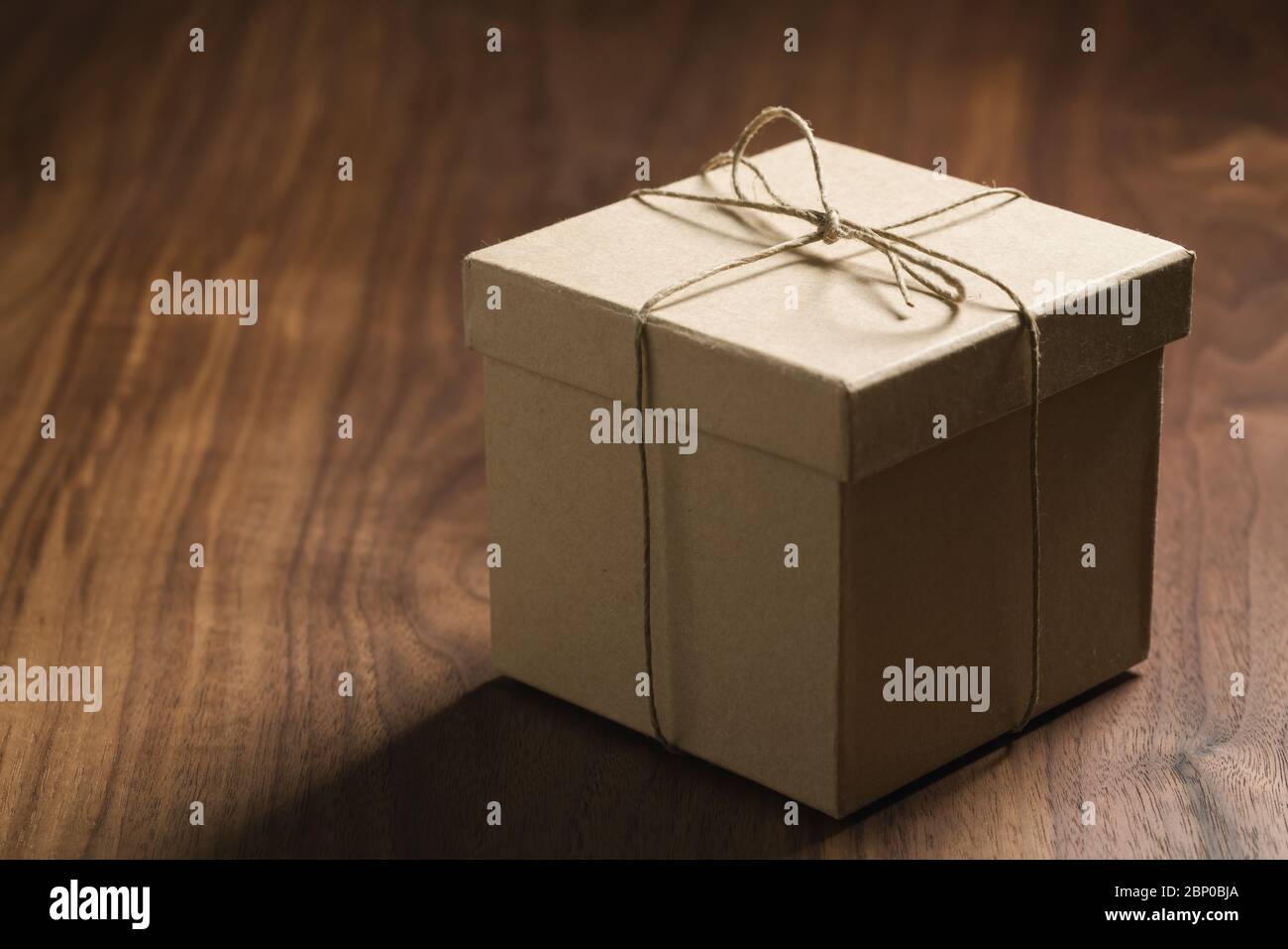brown paper gift box on walnut table with copy space Stock Photo