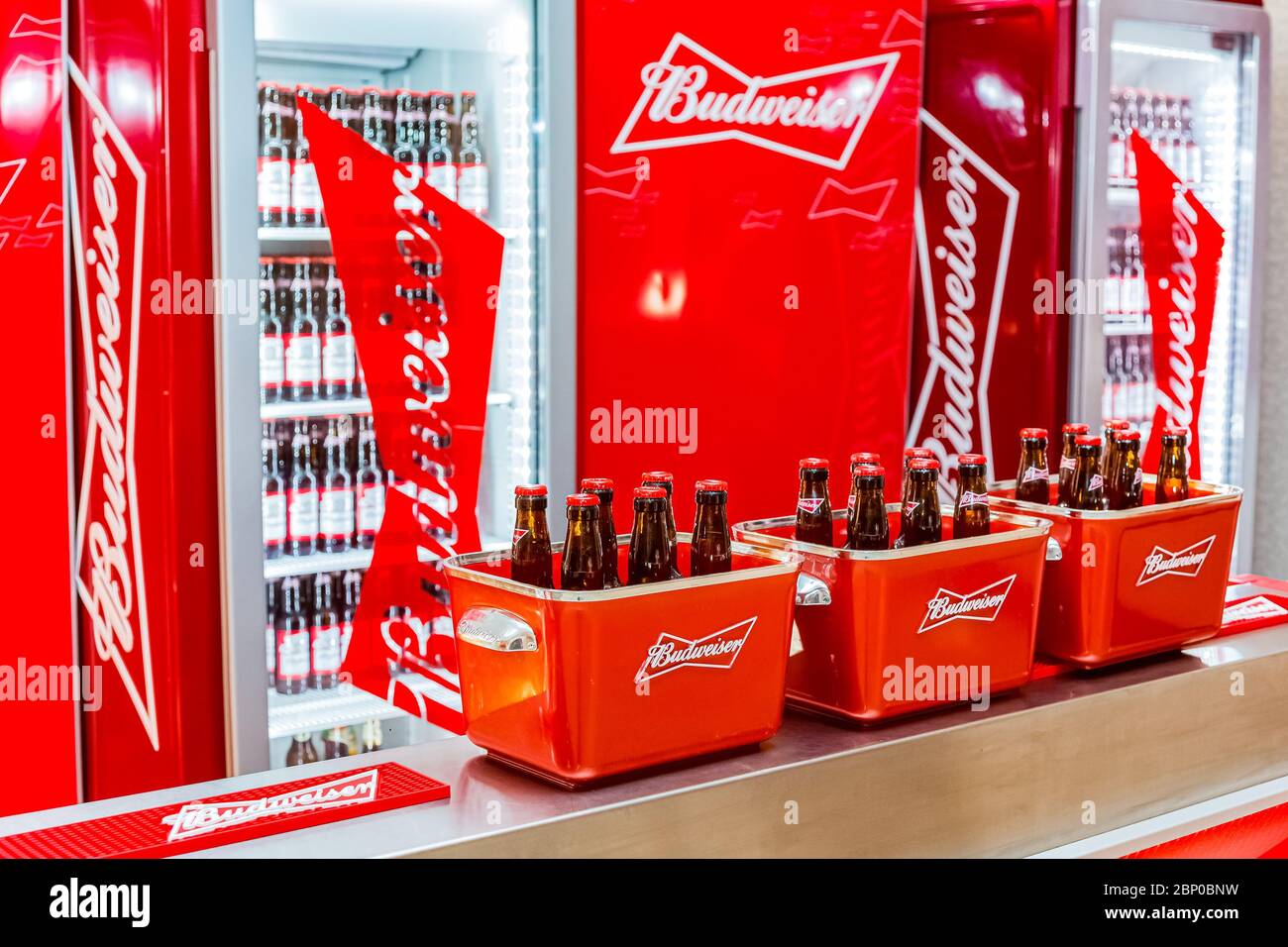 Johannesburg, South Africa - March 27, 2018: Budweiser bottles of beer in red branded ice bucket on bar counter Stock Photo