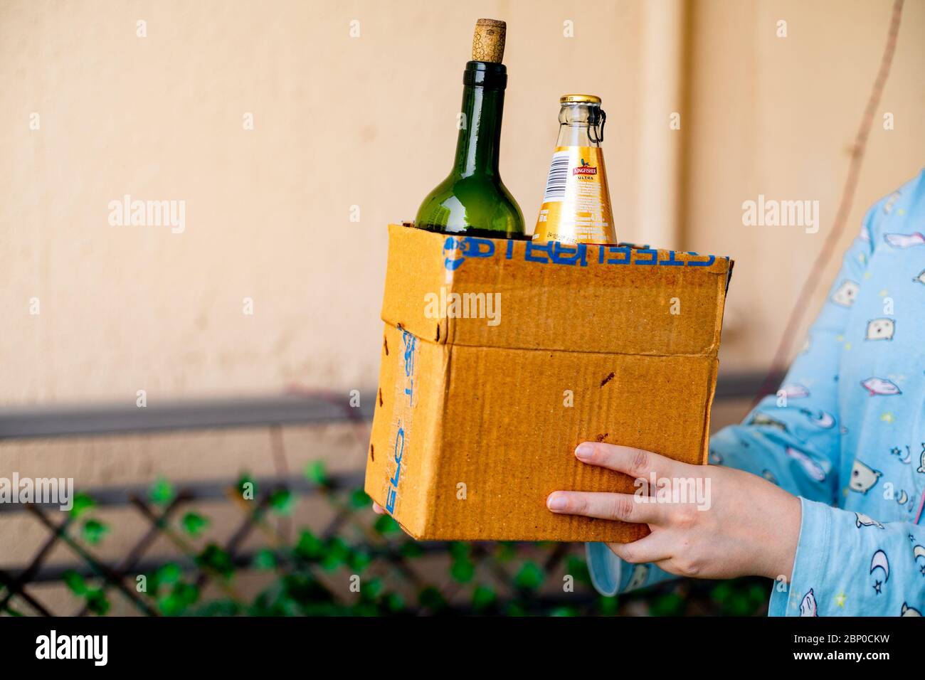 Young Indian Girl Carrying A Cardboard Box Of Alcohol Liquor That Has Been Home Delivered Through An Online App Stock Photo Alamy