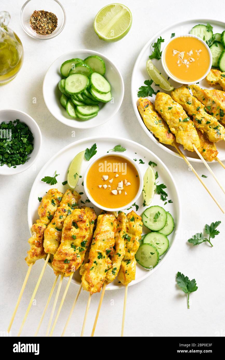 Chicken satay with peanut sauce. Grilled chicken skewers served with