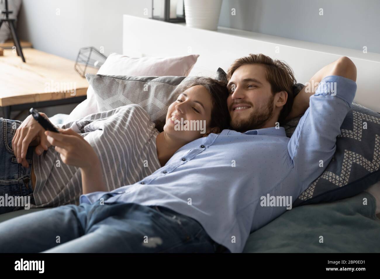 Couple lying together on bed hi-res stock photography and images - Alamy