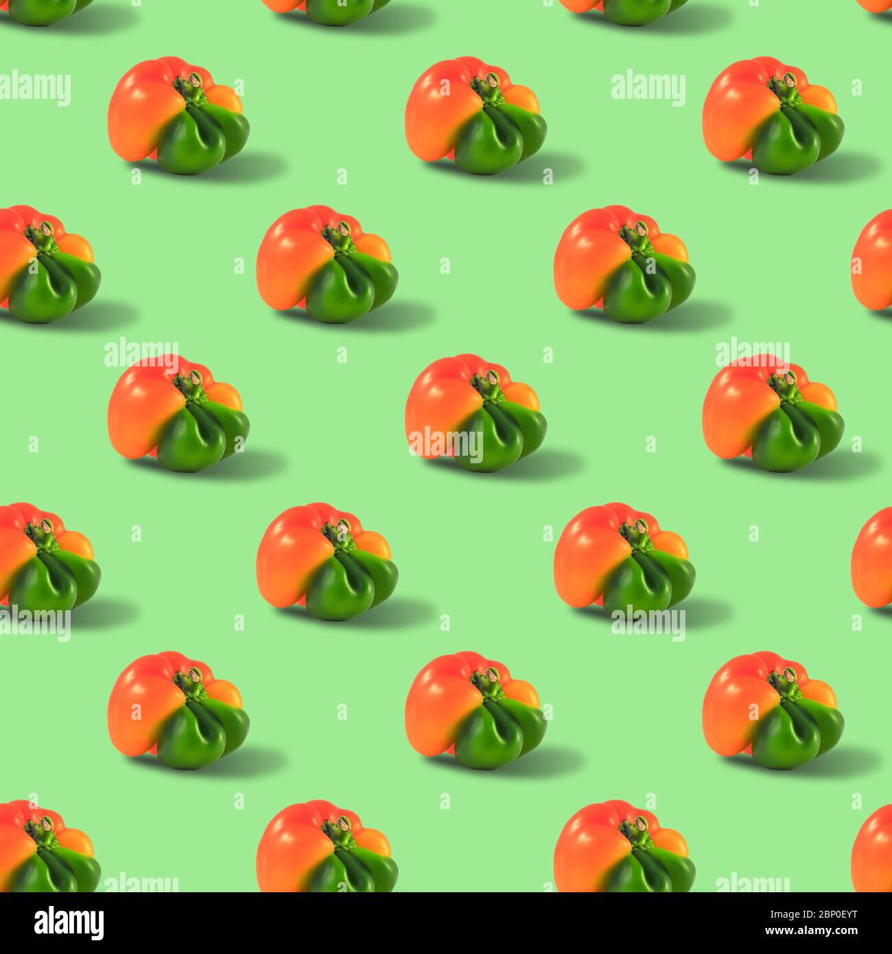 Ugly orange pepper seamless pattern peppers on a green background. Stock Photo