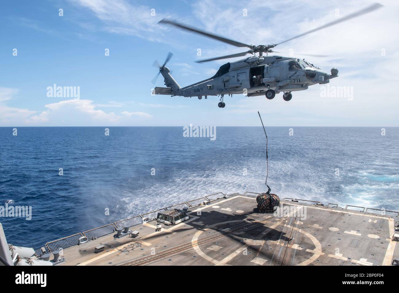 200428-N-OQ778-1374 GULF OF ADEN (April 28, 2020) An MH-60R Sea Hawk, attached to the “Swamp Foxes” of Helicopter Maritime Strike Squadron 74, conducts a simulated vertical replenishment aboard the guided-missile destroyer USS Truxtun (DDG 103) April 28, 2020. Truxtun is deployed to the U.S. 5th Fleet area of operations in support of naval operations to ensure maritime stability and security in the Central Region, connecting the Mediterranean and Pacific through the Western Indian Ocean and three strategic choke points. (U.S. Navy photo by Mass Communication Specialist 3rd Class Kody A. Philli Stock Photo