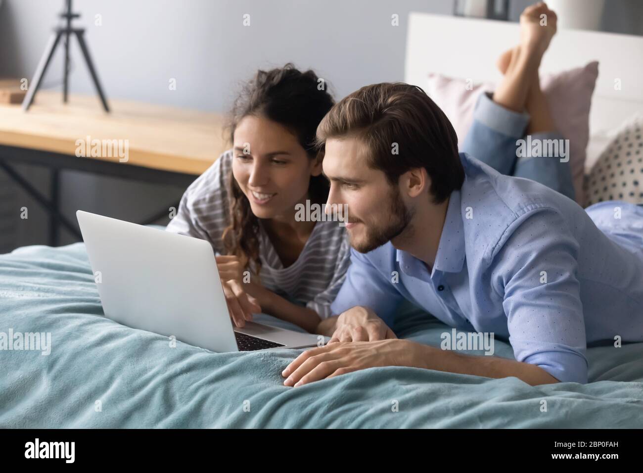 Young couple relax in bedroom using laptop Stock Photo