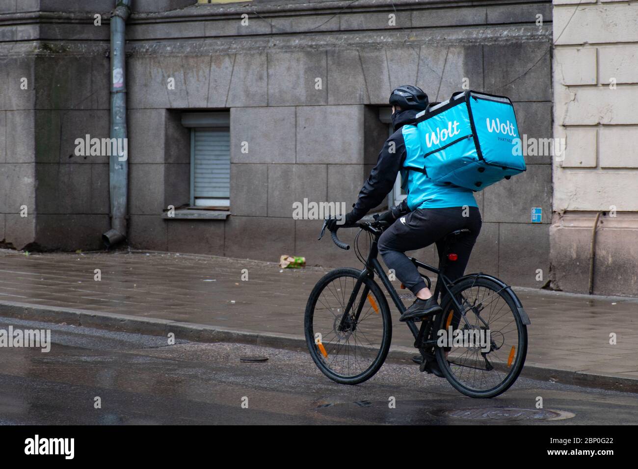 Wolt, online food ordering and delivery service that takes orders via a mobile app, rider with bike Stock Photo