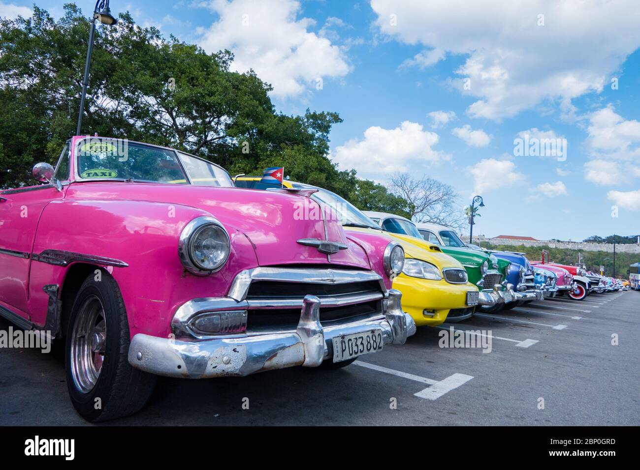 Row of classic Cuban cars of varying colors Stock Photo