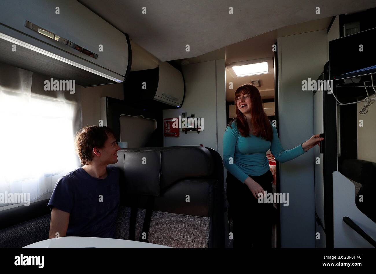 Junior Doctors Jared Leggett and Amy Kitchen chat to one another whilst living in a motorhome in the hospital carpark at The Royal Blackburn Teaching Hospital in East Lancashire following the outbreak of the coronavirus disease. Stock Photo