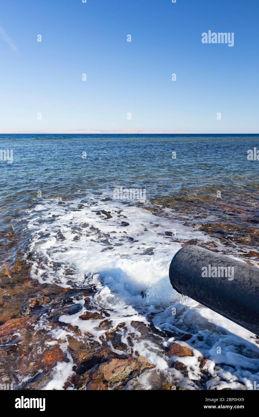 Waste water pipe discharging into the sea Stock Photo