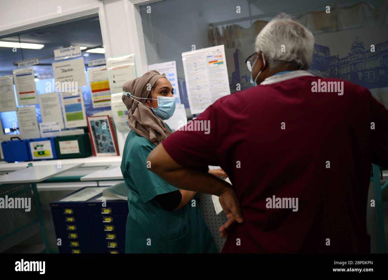Pharmacist Khadija Gire (left) working on Ward D1 at The Royal Blackburn Teaching Hospital in East Lancashire during the outbreak of the coronavirus disease. Stock Photo