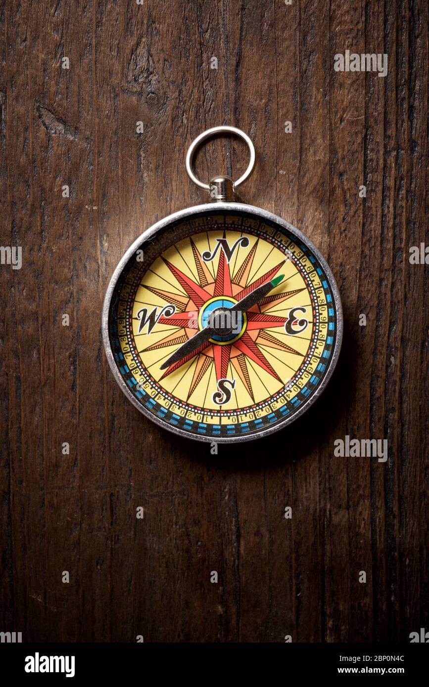 Vintage compass on a wood table. Stock Photo