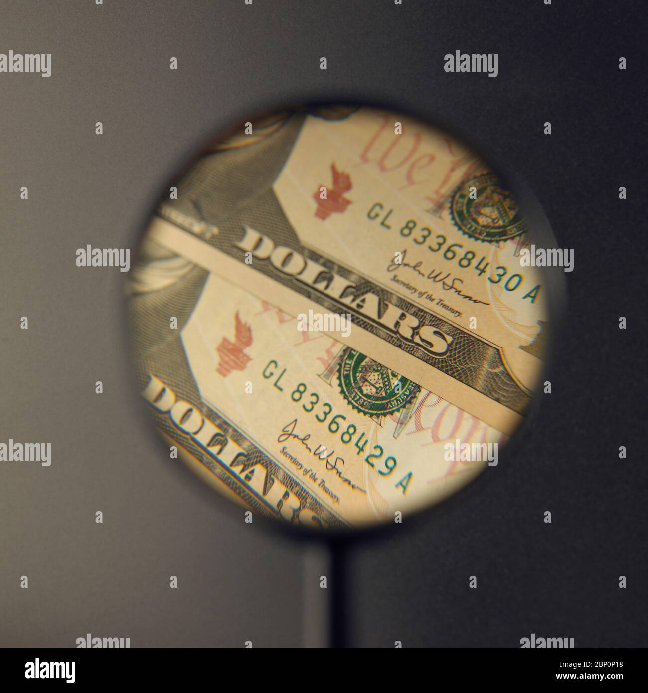 US Dollar notes under the magnifying glass, concept, scrutiny, enlargement, currency, inflation Stock Photo