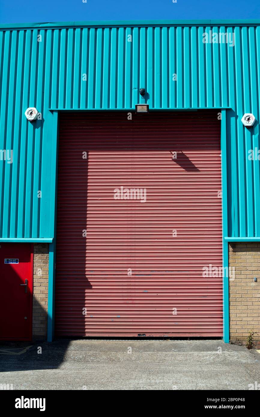 A roller shutter door on a small factory, Warwick, UK Stock Photo