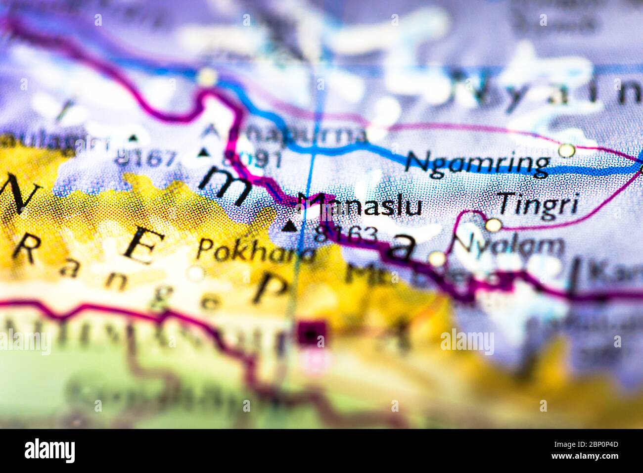 Shallow depth of field focus on geographical map location of Mount Manaslu in Nepal in Asia continent on atlas Stock Photo