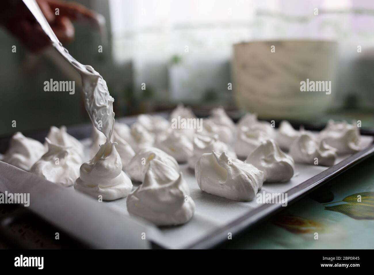 White homemade bizet cooking. Meringues on the baking sheet Stock Photo