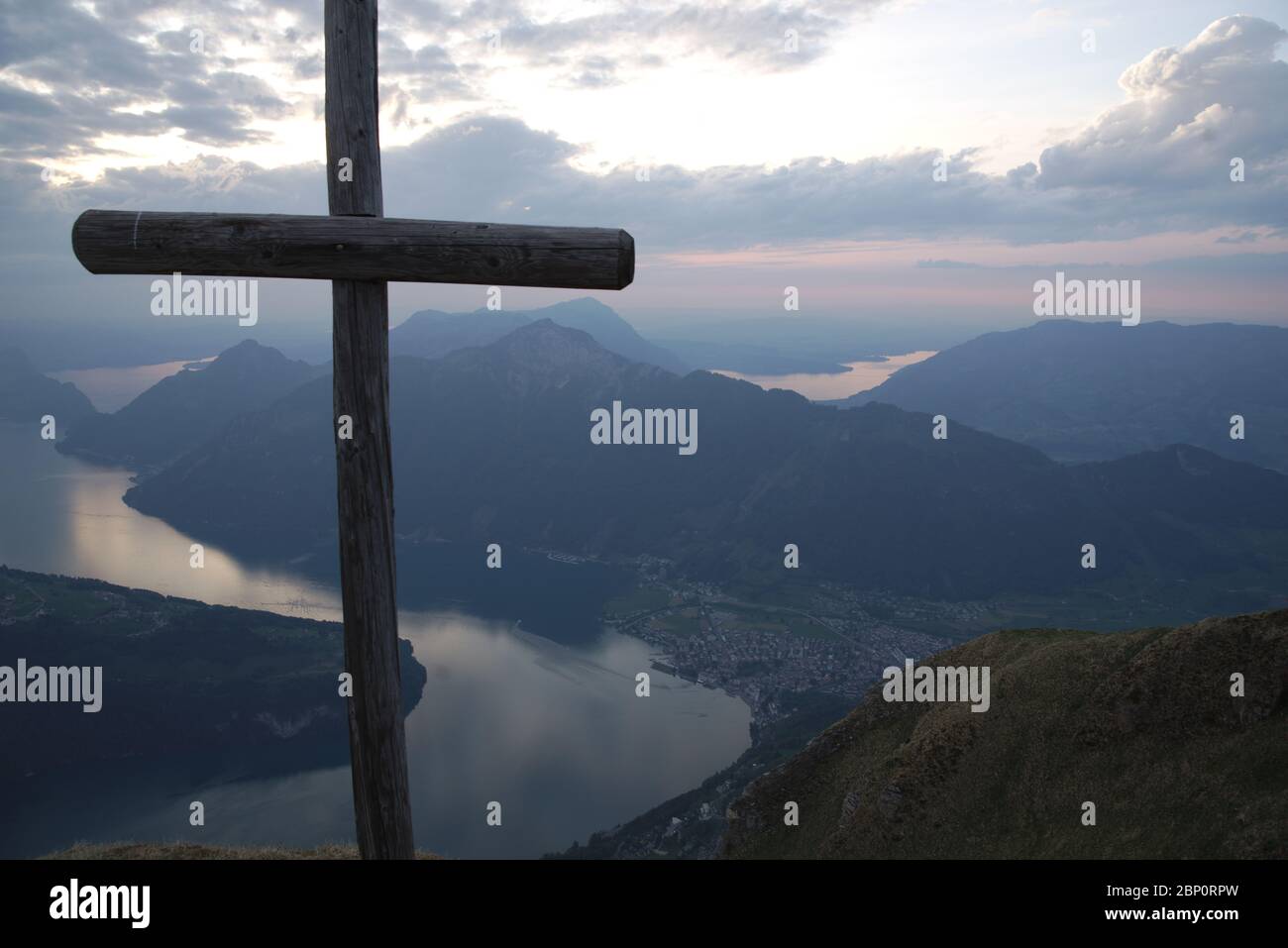 Panorama with peak cross on Fronalpstock overlooking Lake Lucerne and a typical swiss landscape with mountains and lakes. Stock Photo