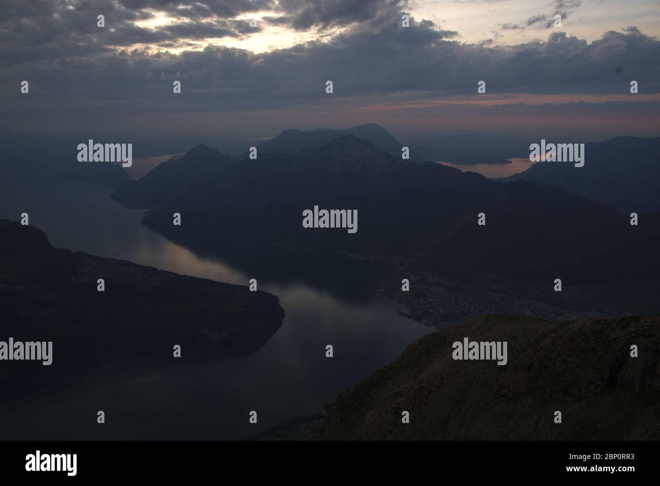 Panorama after sunset from Fronalpstock mountain peak overlooking Lake Lucerne and a typical swiss landscape with mountains and lakes. Stock Photo