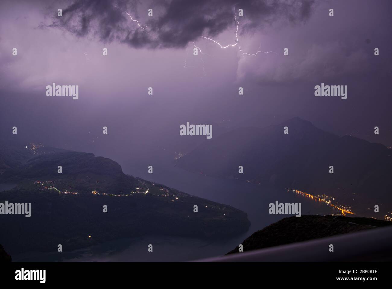 Powerful thunderstorm with flashs seen from the mountain peak Fronalpstock in Switzerland creating a stunning landscape Stock Photo