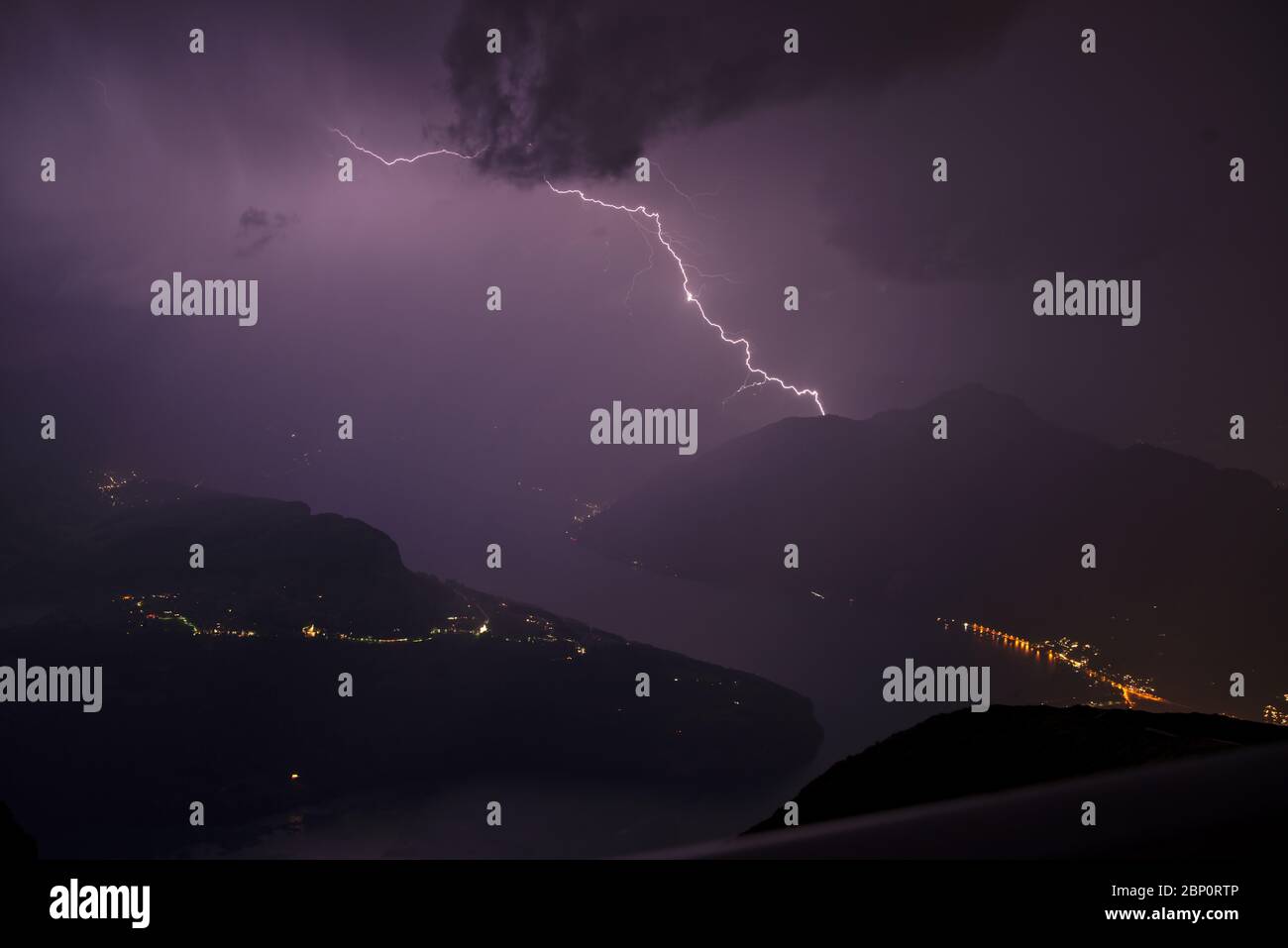 Powerful thunderstorm with flashs seen from the mountain peak Fronalpstock in Switzerland creating a stunning landscape Stock Photo