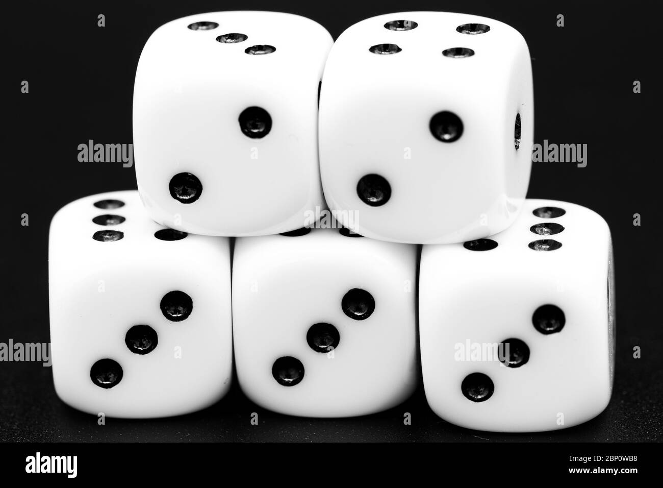 Macro closeup of arranged white dice in front of dark background. Royalty free stock photo. Stock Photo