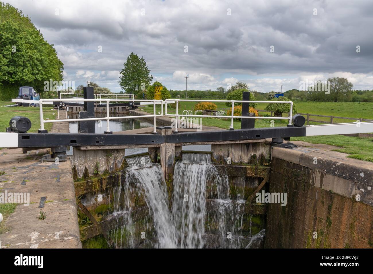 Water flowing from lock gates on a canal Stock Photo