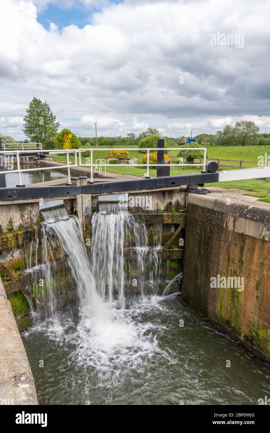 Water flowing from lock gates on a canal Stock Photo