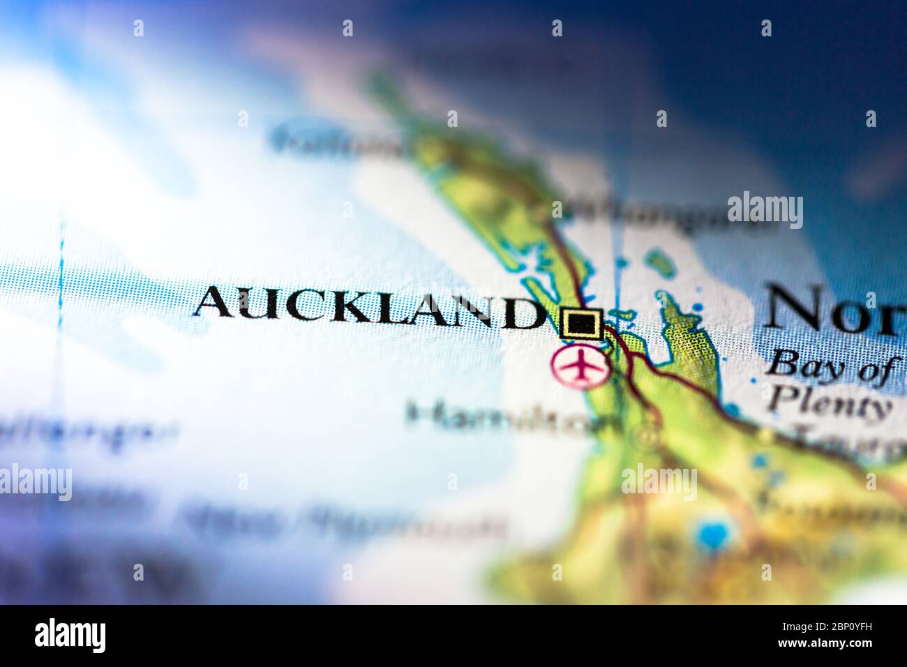 Shallow depth of field focus on geographical map location of Auckland city in New Zealand Oceania Australasia continent on atlas Stock Photo