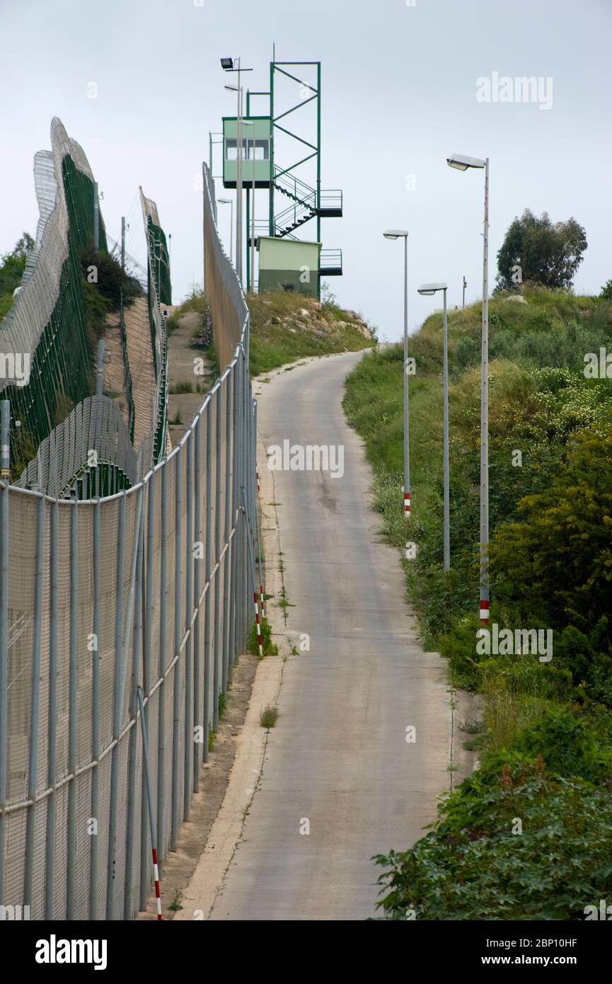 MELILLA,SPAIN-APRIL 21 : Perimeter fence that separates the Spanish enclave of Melilla and Morocco on April 21,2010 in Melilla, Spain. The fence which marks the border around the Spanish enclave in northern Morocco was build to discourage illegal immigrants from attempting to enter to Melilla.  ( Photo by Jordi Cami) Stock Photo