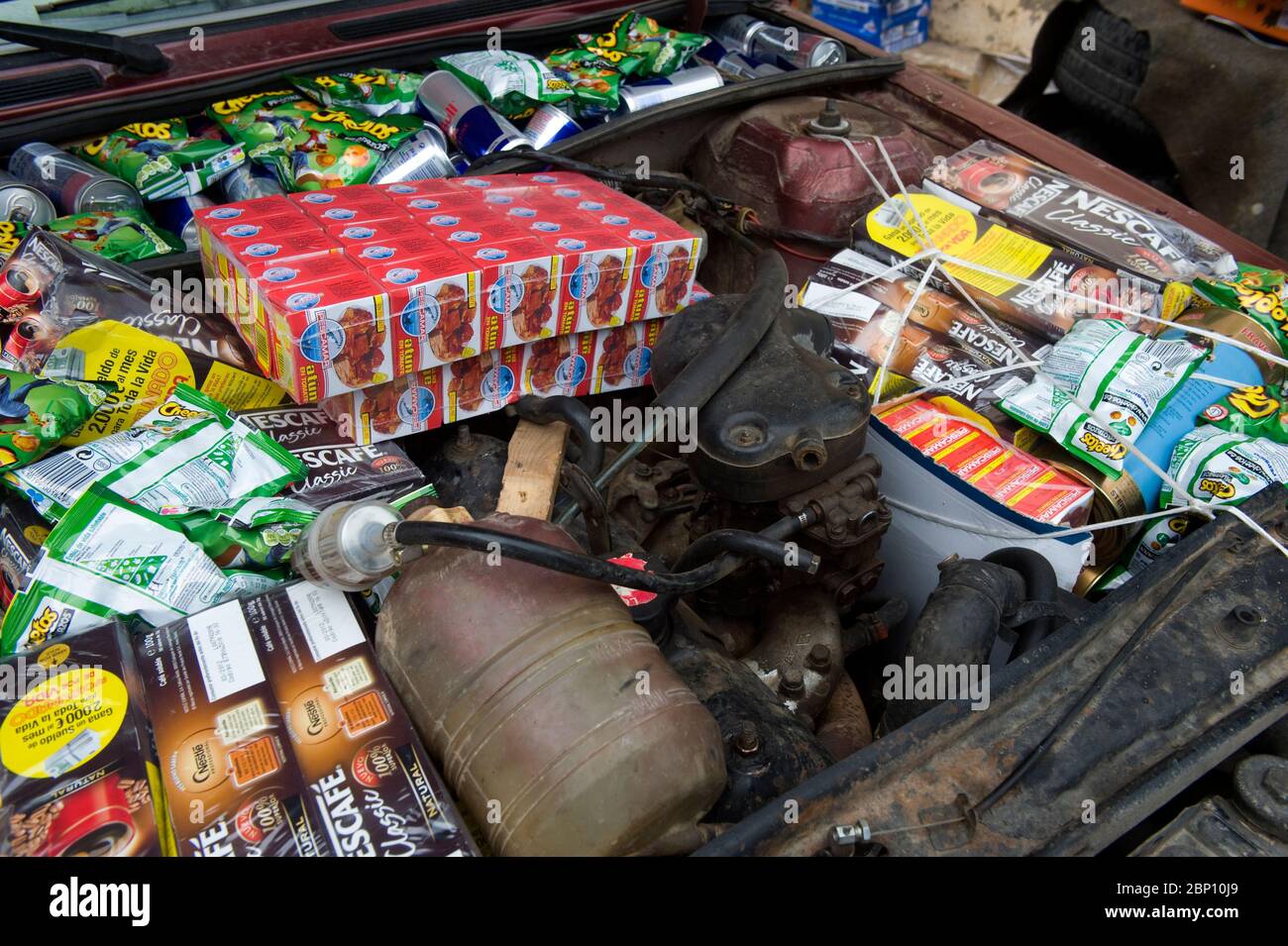 MELILLA, SPAIN - APRIL 22, 2010 : Food items hidden in a car engine ready to be smuggled into Morocco. Warehouses located around the traditional cross border of Beni Anzar supply all type of goods being smuggled introduced in  Morocco on April 22 , 2010 in Melilla. Spain. ( Photo by Jordi Cami  ) Stock Photo