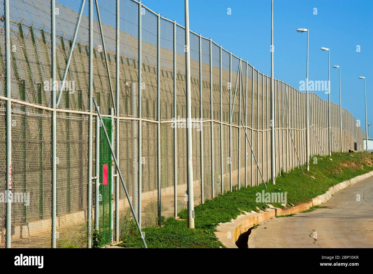MELILLA,SPAIN-APRIL 19 : Perimeter fence that separates the Spanish enclave of Melilla and Morocco on April 19,2010 in Melilla, Spain. The fence which marks the border around the Spanish enclave in northern Morocco was build to discourage illegal immigrants from attempting to enter to Melilla.( Photo by Jordi Cami) Stock Photo