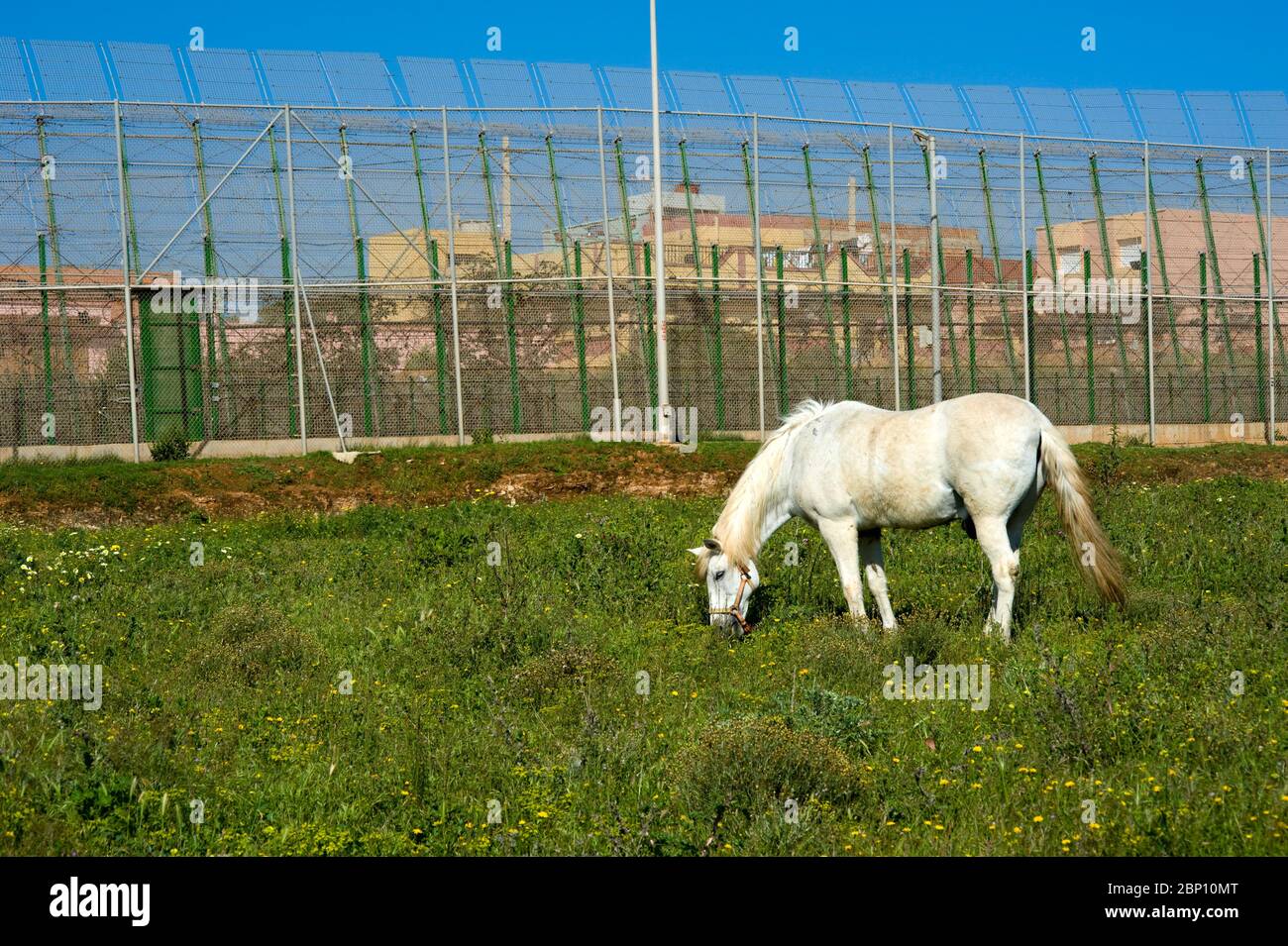 MELILLA,SPAIN-APRIL 19 : Perimeter fence that separates the Spanish enclave of Melilla and Morocco on April 19,2010 in Melilla, Spain. The fence which marks the border around the Spanish enclave in northern Morocco was build to discourage illegal immigrants from attempting to enter to Melilla.  ( Photo by Jordi Cami) Stock Photo