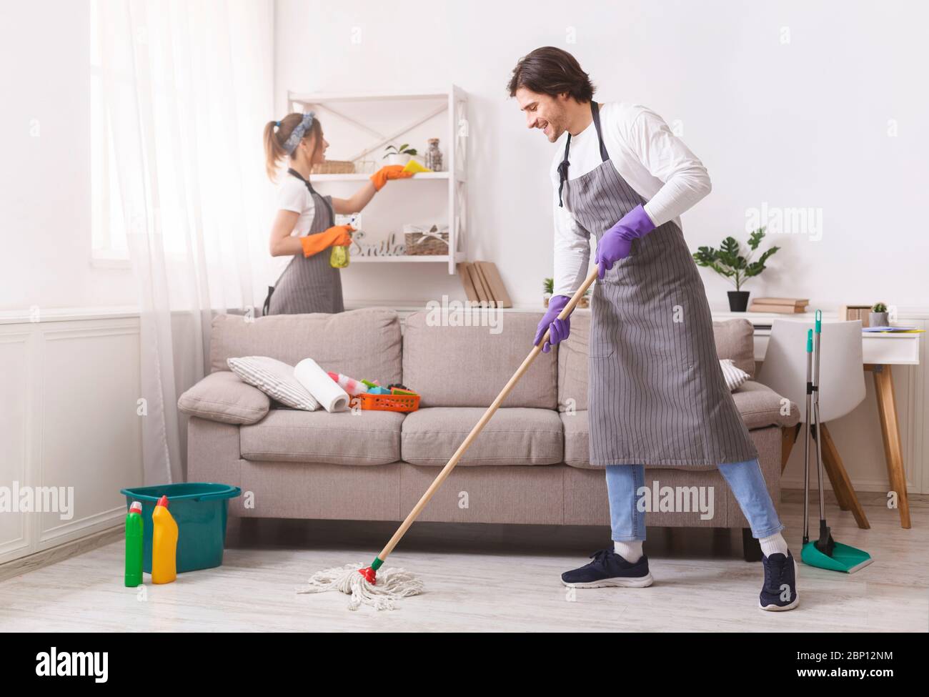Residential Cleaning Services. Couple Of Skilled Housekeepers Tidying Up Apartment Stock Photo