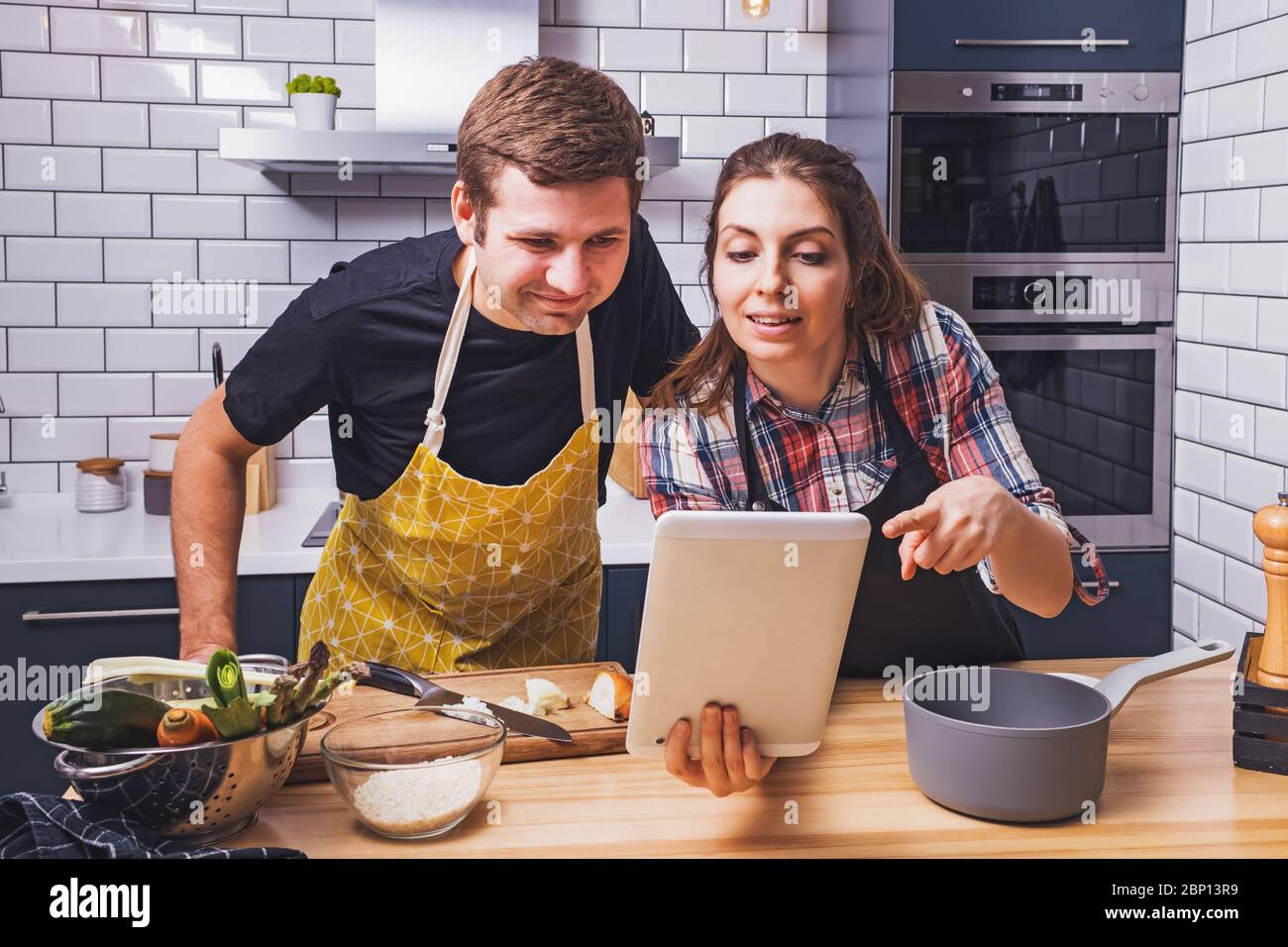 Young couple cooking together at home Stock Photo