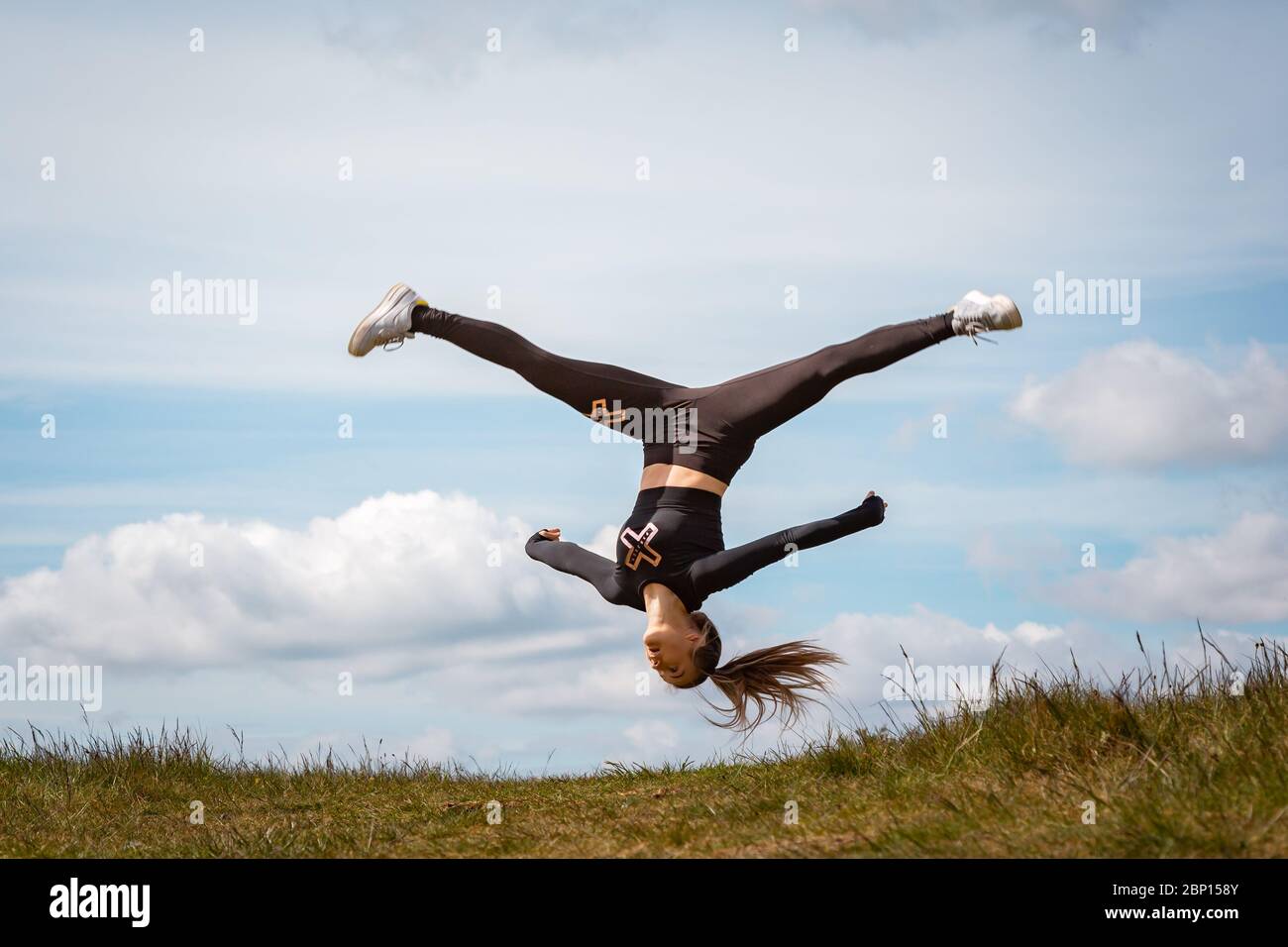 Acrobatics in the park, Waseley Hills, Worcs, UK. 17th May, 2020. After the slight easing of the lockdown in England, 15-year-old Amelia Hubbard can at last practice her acrobatic dance moves in her local open space at Waseley Hills Country Park, Worcestershire, rather than in her back garden at home. Amelia is hoping to take up a place at Birmingham Ormston Academy to study Dance full time, and is happy that she has not needed to take her GCSE exams this year due to schools being closed. Credit: Peter Lopeman/Alamy Live News Stock Photo