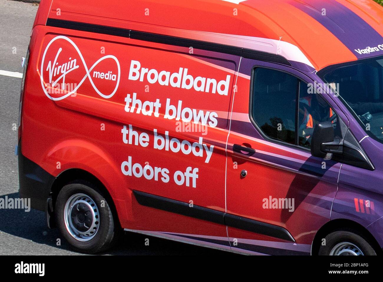 Virgin Media Broadband service ' that blows the bloody doors off' Ford Transit Custom 300Leader vehicle; Vehicular traffic moving vehicles, driving vehicle on UK roads, motors, van motoring on the M6 motorway highway Stock Photo