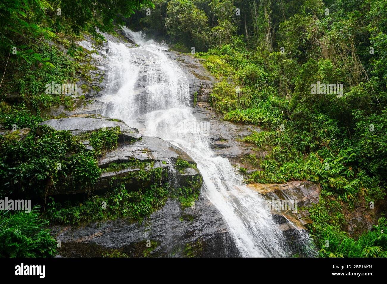 Beautiful waterfall near the rock in Rio de Janeiro's Tijuca Forrest in Brazil Stock Photo