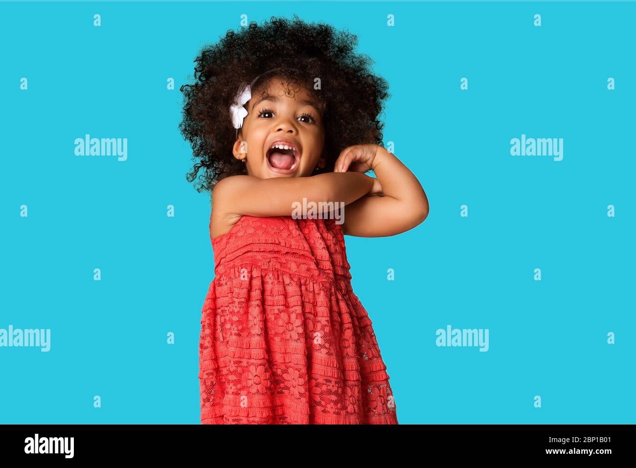 Portrait of cheerful happy african american little girl isolated over colored background Stock Photo