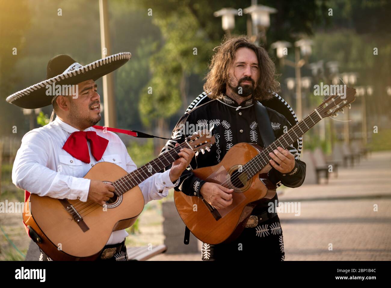 Mexican musicians play musical instruments in the city. City street in the summer. Stock Photo