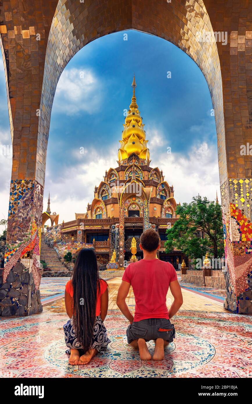 Happy travel couple explore scenery Thai architecture in the Lanna style in buddhist Thailand temple. Asian culture and religion Stock Photo
