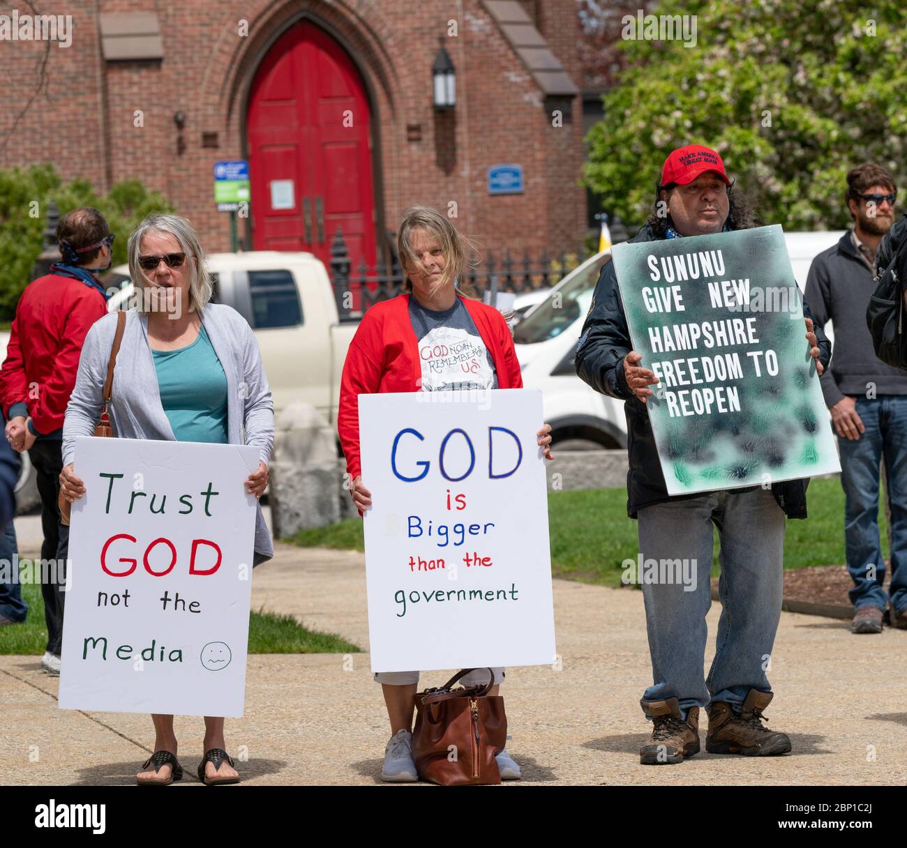 May 16, 2020, New Hampshire State House, Concord, New Hampshire, USA: Christians holding signs during a prayer rally organized by Reopen NH, to protest closed churches and New Hampshires ban on gatherings of more than 10 people amid COVID-19 pandemic at New Hampshire State House Plaza in Concord. Stock Photo